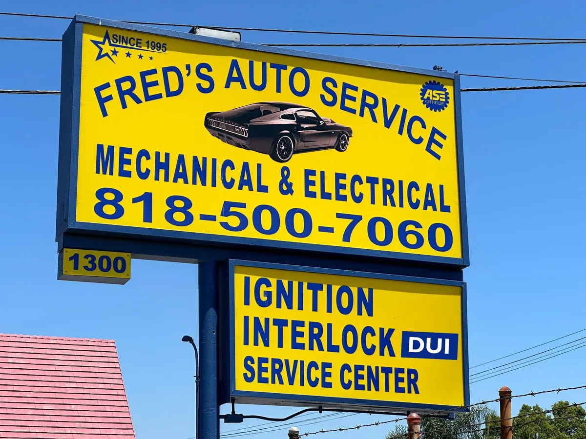 Fred's Auto Service street sign: Mechanical & Electrical, 818-500-7060, Ignition Interlock Service Center