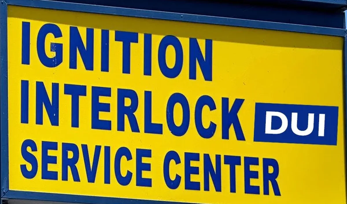 The Ignition Interlock DUI Service Center panel on Fred's Auto Service pole sign